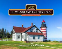 Promotional sign for the 2027 New England Lighthouses scenic engagement calendar over a lighthouse and house against a blue sky.
