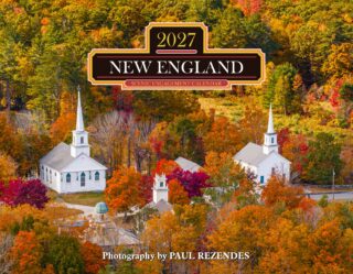 Autumn aerial view of a white church campus surrounded by bright fall foliage; calendar title reads '2027 NEW ENGLAND' on a decorative badge.