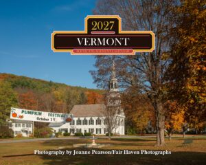 Autumn scene with a large Pumpkin Festival banner reading 'PUMPKIN FESTIVAL' and date October 19 in front of white houses and fall-colored trees.